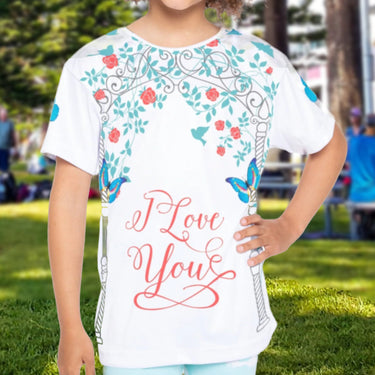 Girls’ butterfly sports jersey with colorful flower design and “I love you” message, moisture-wicking polyester, part of Paisley’s Corner Collection, ideal for school and active wear, girl in butterfly garden top
